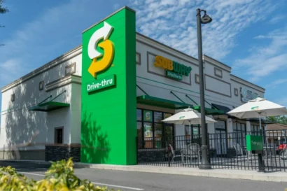 An image of a Subway restaurant with a sign in front of the restaurant